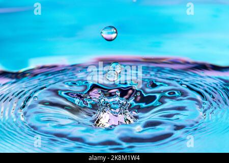 Pure water drop splash on the surface of the water. Stock Photo