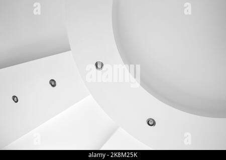 Abstract minimal architecture fragment with spot lights in white round ceiling decoration. Architectural photo background Stock Photo