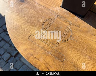 Public wireless smartphone station on wooden table Stock Photo