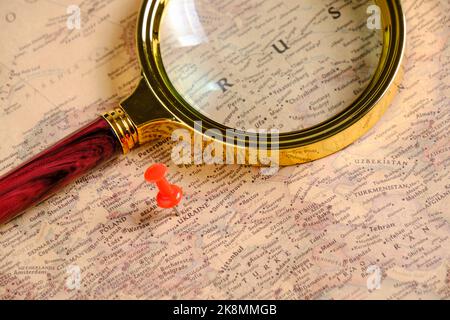 Magnifying glass and red button on map pointing to territory Ukraine Stock Photo