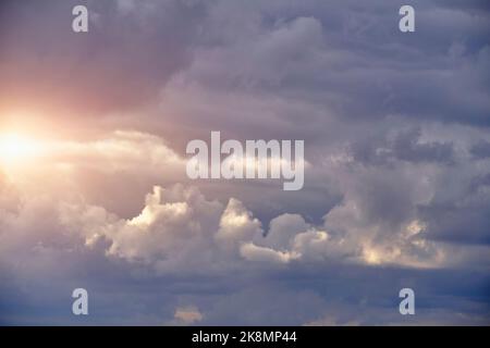 Breaking sunlight through gap of storm clouds Stock Photo