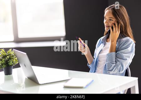 Informal Call. Happy young woman in glasses calling her friend, talking and asking about something, using laptop Stock Photo