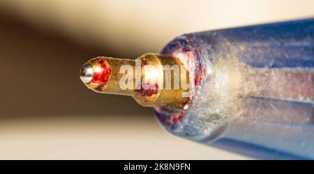 Close up image of a ball point pen with blurred background and selective focus. Detailed photography of a ball pen. Stock Photo