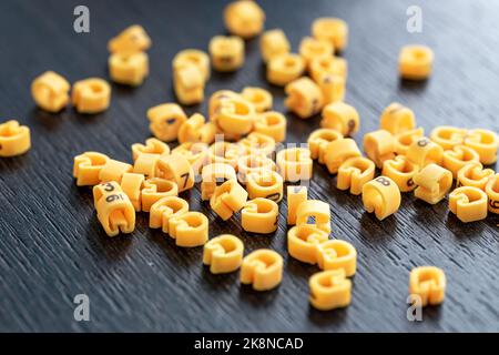 Cable markers scattered on the table, macro shot. Stock Photo