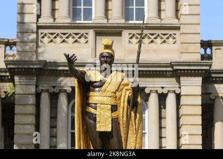 A closeup of King Kamehameha statue in downtown Honolulu, with Iolani palace background Stock Photo