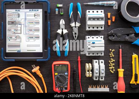 Different electrical tools on wooden background, flat lay. Stock Photo