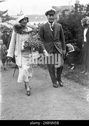 Ålesund 1938 Crown Prince Olav and Crown Princess Märtha visit Ålesund. Here the two together, on a walk in the city. Märtha with light suit with reefskin collar and large flower bouquet. Olav in suit, and with skipper hat. Photo: Arne Sylte / NTB Stock Photo