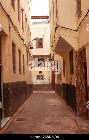 A vertical shot of a narrow path between old buildings Stock Photo - Alamy