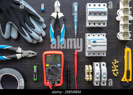 Different electrical tools on wooden background, flat lay. Stock Photo
