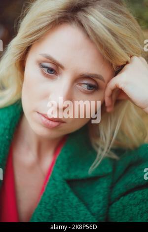 Pensive mid woman portrait, relaxing outdoors on a holiday. Portrait of mature woman planning her future. Stock Photo