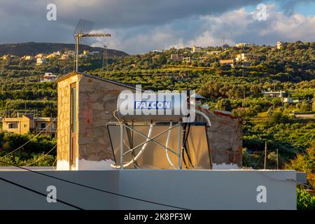 Domestic solar water heater on the roof of an apartment block near Rethymnon in Crete a Greek Island in the Mediterranean. Stock Photo
