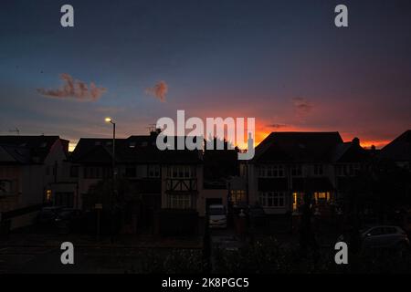 Sun sets over West London leaves a blue and orange tint in the sky Stock Photo