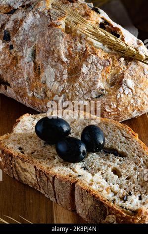 typical Apulian bread with wholemeal flour and black olives Stock Photo