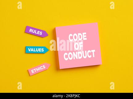 The word code of conduct on pink note paper. The components of code of conduct rules, values and ethics. Stock Photo