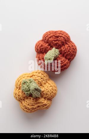 Cute crochet knitted pumpkins on gray background with a copy space Stock Photo