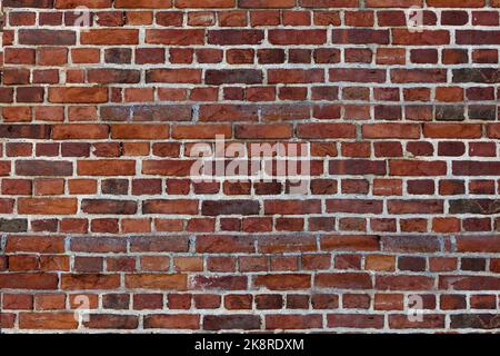 Old wall red briks tiled background, regular block texture. Wallpaper terracotta rustic wall surface Stock Photo