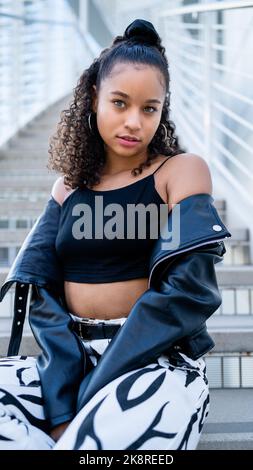Multiracial Woman Seated on a Modern Concrete Stairway in Downtown San Jose Stock Photo
