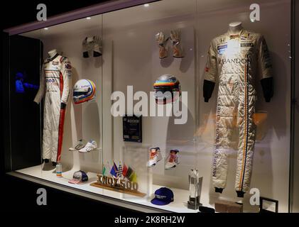 Display of Fernando Alonso's trophies crash helmets gloves boots nomex racing clothes at the Museum and Circuit Oviedo Asturias Spain Stock Photo