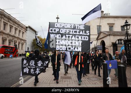 London, UK. 24th Oct, 2022. Protesters seen carrying a banner during the demonstration. Hundreds of people marched from Downing Street via Chinatown to the Chinese Embassy in London, to protest against the assault incident in which a Hong Kong protester Bob Chan, who was seen being pulled into the grounds of a Chinese consulate in Manchester and beaten by staff on October 17, 2022. Credit: SOPA Images Limited/Alamy Live News Stock Photo