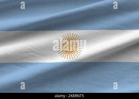 Argentina flag with big folds waving close up under the studio light indoors. The official symbols and colors in fabric banner Stock Photo