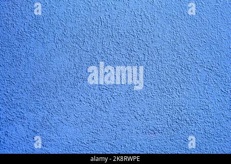 Background of blue concrete wall. Decorative embossed concrete and glue plaster. Blue plastered wall. Plaster textured background. Blurred photo. Stock Photo