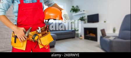 Cropped shot of young repairman wearing a tool belt with various tools Stock Photo