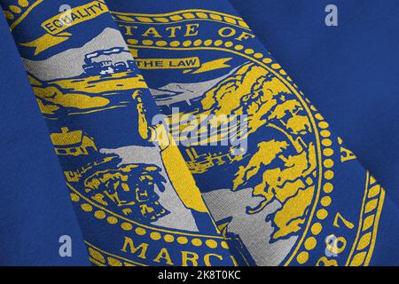 Nebraska US state flag with big folds waving close up under the studio light indoors. The official symbols and colors in fabric banner Stock Photo