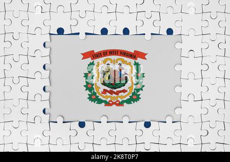 West Virginia US state flag in frame of white puzzle pieces with missing central parts Stock Photo