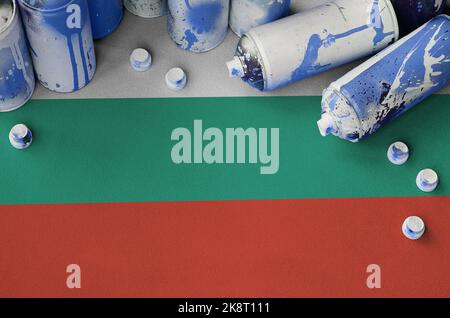 Bulgaria flag and few used aerosol spray cans for graffiti painting. Street art culture concept, vandalism problems Stock Photo