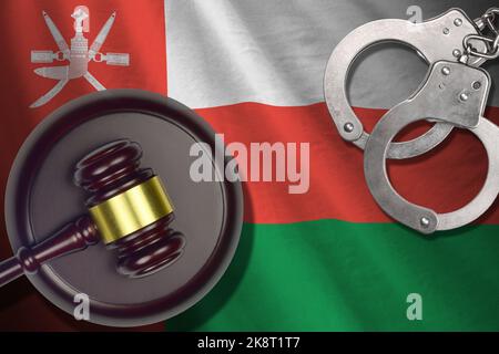 Oman flag with judge mallet and handcuffs in dark room. Concept of criminal and punishment, background for guilty topics Stock Photo