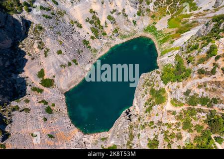 Aerial view about Blue Lake (Croatian: Modro jezero or Plavo jezero) is a karst lake located near Imotski in southern Croatia. Stock Photo