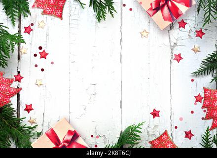 Christmas composition. Gift box, pine, fir branches and star on wooden white background. Flat lay, copy space. Stock Photo