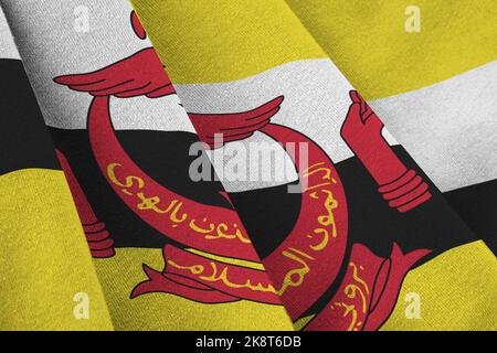 Brunei Darussalam flag with big folds waving close up under the studio light indoors. The official symbols and colors in fabric banner Stock Photo