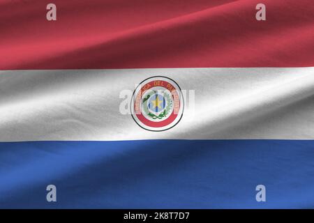 Paraguay flag with big folds waving close up under the studio light indoors. The official symbols and colors in fabric banner Stock Photo