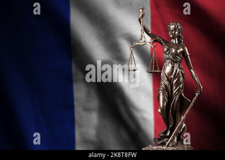 France flag with statue of lady justice and judicial scales in dark room. Concept of judgement and punishment, background for jury topics Stock Photo