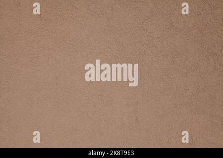 Brown, terracotta texture and background. Decorated surface with round ornamental embossed pattern. Pale light-brown wall surface Stock Photo