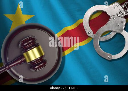 Democratic Republic of the Congo flag with judge mallet and handcuffs in dark room. Concept of criminal and punishment, background for guilty topics Stock Photo