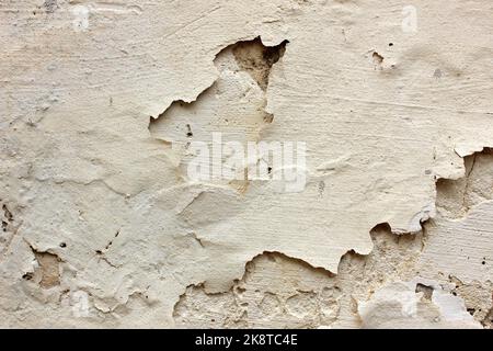 Old paint on the dirty cement wall background. Wall with shabby damaged plaster. Texture, pattern, background. Copy space. Stock Photo