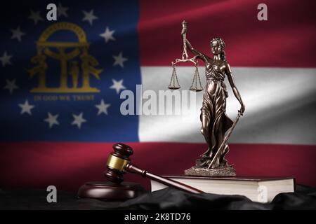 Georgia US state flag with statue of lady justice, constitution and judge hammer on black drapery. Concept of judgement and punishment Stock Photo