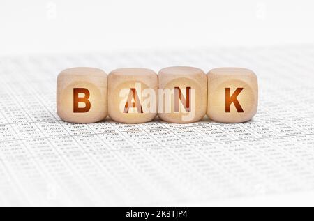 Business concept. On the table with documents are wooden cubes with the inscription - BANK Stock Photo