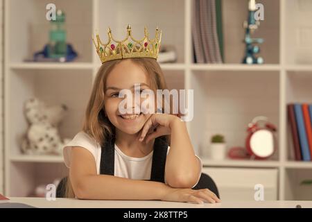 smiling child in queen crown at school classroom Stock Photo