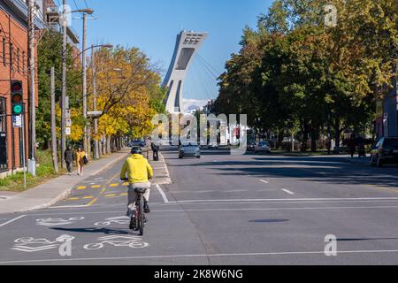 Montreal, CA - 10 October 2022: Man riding a bike on Rachel street in Autumn Stock Photo