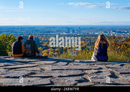 Montreal, CA - 10 October 2022: People looking at the view over Montreal city from Outremont lookout in Autumn Stock Photo