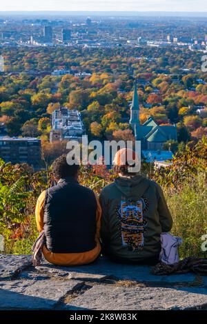 Montreal, CA - 10 October 2022: People looking at the view over Montreal city from Outremont lookout in Autumn Stock Photo