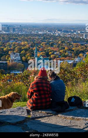 Montreal, CA - 10 October 2022: People looking at the view over Montreal city from Outremont lookout in Autumn Stock Photo