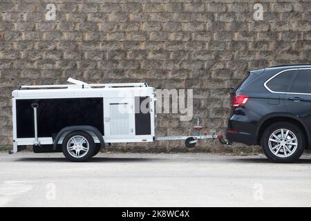 Parked travel dog trailer. All-road vehicule hooked Stock Photo