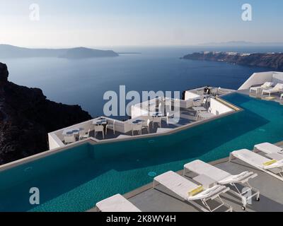 Luxury hotel swimming pool view over the Caldera. Aegean Cyclades Island of Santorini, Greece. Stock Photo