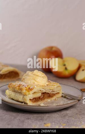 piece of an apple strudel roll with cinnamon and ice cream on top Stock Photo