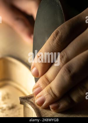 smoothing fiddle table on maker workbench Stock Photo