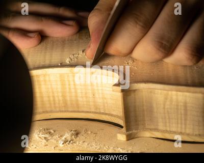 smoothing fiddle table on maker workbench Stock Photo